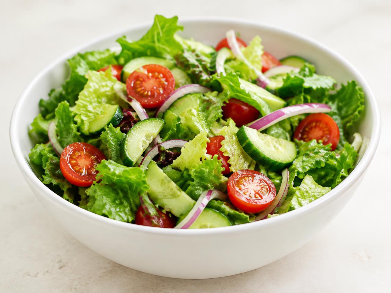 Fresh green salad with tomatoes, cucumber and red onion
